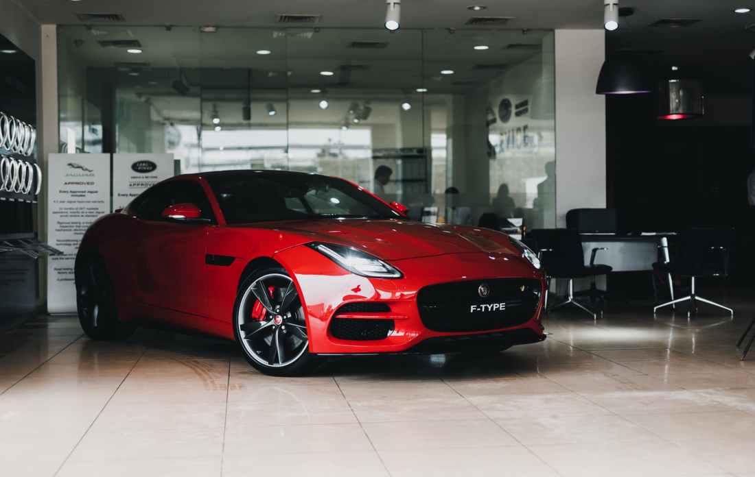 shallow focus photo of red coupe